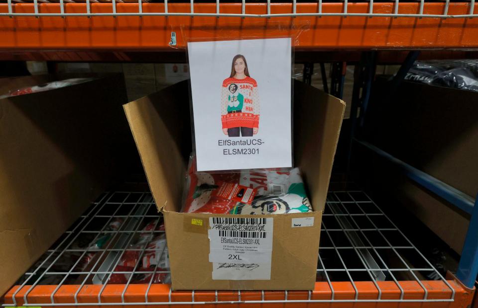 Boxes full of Christmas sweaters at the UglyChristmasSweater.com warehouse in Commerce Township, Mich., on Oct. 12, 2021. Fred and Mark Hajjar, co-founders of UglyChristmasSweater.com which sells them online have a large supply of these types of sweaters and other items stuck on freighters off the coast of California.