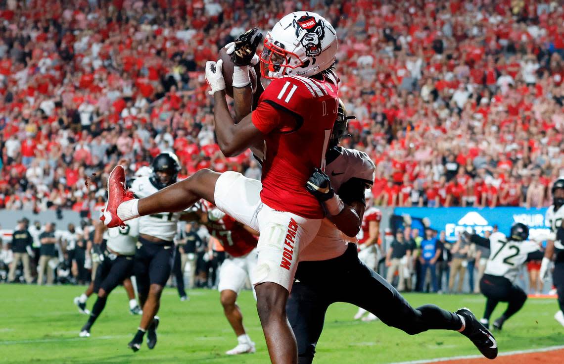 N.C. State wide receiver Darryl Jones (11) pulls in a 1-yard touchdown reception as Wake Forest defensive back Gavin Holmes (7) defends during the second half of N.C. State’s 30-21 victory over Wake Forest at Carter-Finley Stadium in Raleigh, N.C., Saturday, Nov. 5, 2022.