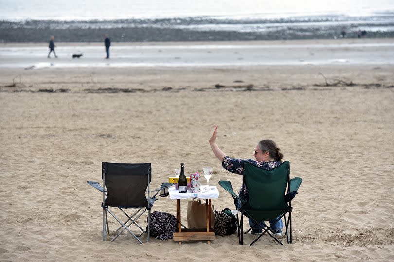 Coronavirus Pandemic. Covid 19. May Bank Holiday weather pictures. Swansea and the Mumbles. Dining alfresco on Swansea beach. -Credit:Richard Swingler