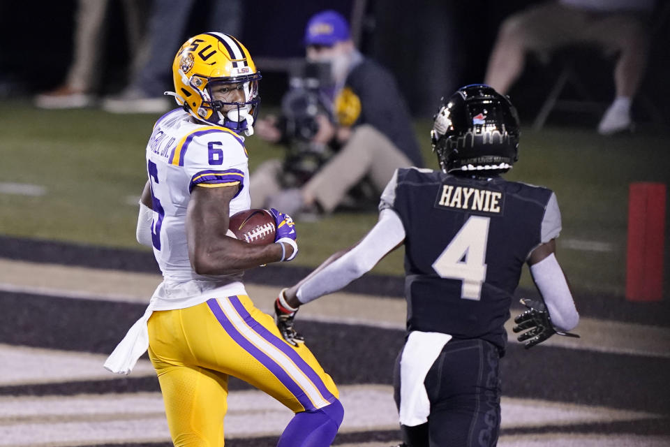 LSU wide receiver Terrace Marshall Jr. (6) looks back at Vanderbilt cornerback Randall Haynie (4) as Marshall scores a touchdown on a 51-yard pass reception in the first half of an NCAA college football game Saturday, Oct. 3, 2020, in Nashville, Tenn. (AP Photo/Mark Humphrey)