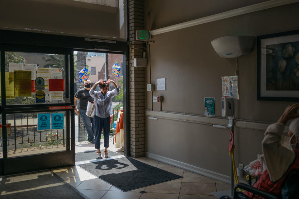 Lydia Yang says goodbye to her father Noh Park during a <a href="https://time.com/5856736/fathers-day-la-nursing-home-coronavirus/" rel="nofollow noopener" target="_blank" data-ylk="slk:socially distant Father's Day;elm:context_link;itc:0;sec:content-canvas" class="link ">socially distant Father's Day</a> event at a Los Angeles nursing home.<span class="copyright">Isadora Kosofsky for TIME</span>