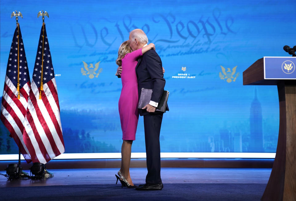 WILMINGTON, DELAWARE - DECEMBER 14: U.S. President-elect Joe Biden (R) embraces his wife Dr. Jill Biden after speaking about the Electoral College vote certification process at The Queen theater on December 14, 2020 in Wilmington, Delaware. On Monday, presidential electors of the Electoral College gathered in state capitals across the nation to cast their ballots for president and vice president. Their ballots will be formally counted during a joint session of Congress on January 6, 2021. (Photo by Drew Angerer/Getty Images)