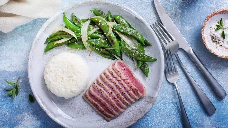 Sliced tuna steak with rice and veggies