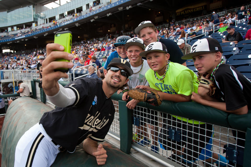 June 24, 2014: Vanderbilt pitcher Adam Ravenelle (12) does a selfie with a bunch of young fans before the game against the Virginia during the College World Series at TD Ameritrade Park in Omaha, Nebraska. Virginia won over Vanderbilt 7 to 2. (Photo by John S. Peterson/Icon SMI/Corbis via Getty Images)