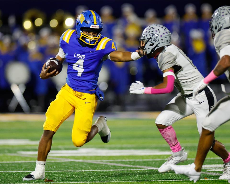 Gahanna Lincoln’s Diore Hubbard fends off a tackle from Pickerington North’s Malachi Taylor during Gahanna's 35-28, double-overtime home win Friday.