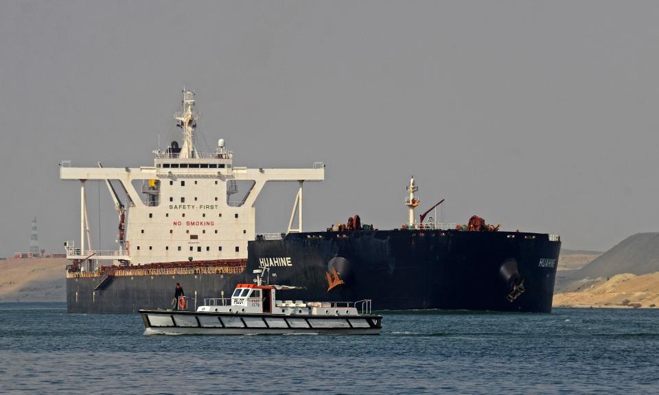 Egyptian coast guards patrol as a ship navigates the Suez Canal on March 30, 2021, a day after a cargo vessel was dislodged from its banks. - Egyptian authorities have presented the freeing of the megaship, which was stuck for nearly a week and caused a 425- ship tailback to the north and south, as a major vindication of the country's engineering and salvage capabilities. (Photo by Tarek WAJEH / AFP) (Photo by TAREK WAJEH/AFP via Getty Images)