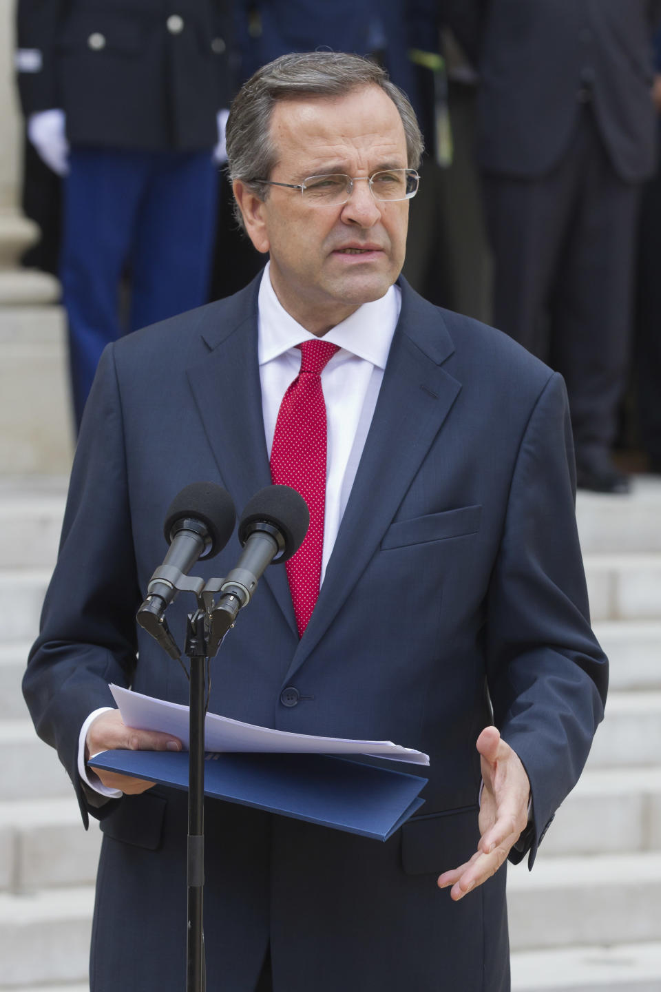 Greece's Prime Minister Antonis Samaras, gestures as he speaks to reporters during a joint statement with France's President Francois Hollande after their meeting at the Elysee Palace, Paris, Saturday, Aug. 25, 2012. (AP Photo/Michel Euler)