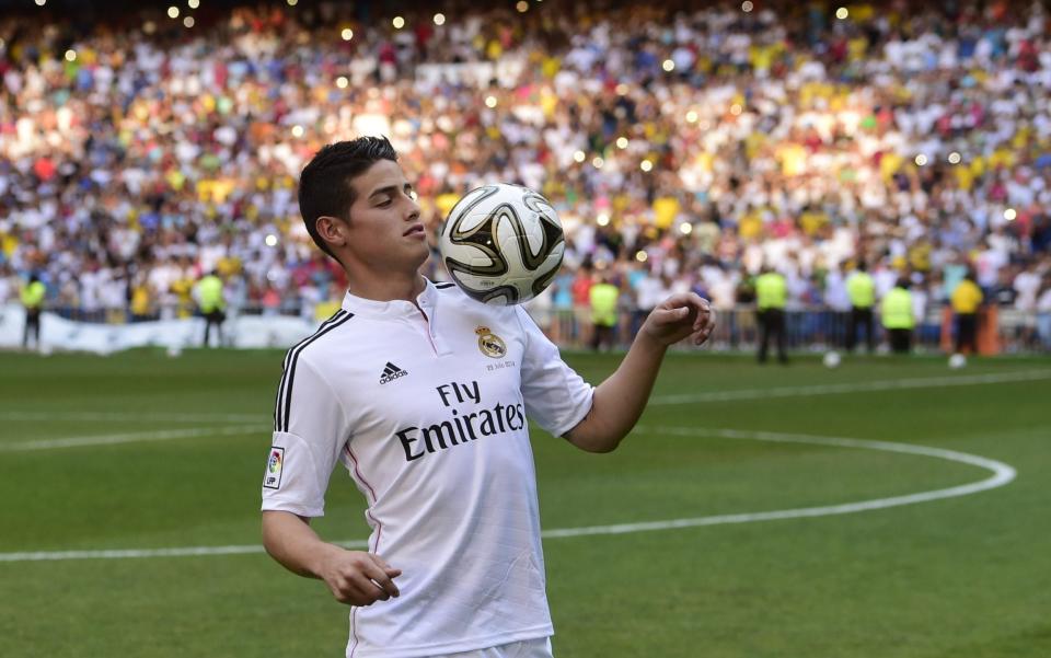 Colombian striker formerly at AS Monaco James Rodriguez controls a ball during his presentation at the Santiago Bernabeu stadium following his signing with Spanish club Real Madrid - AFP