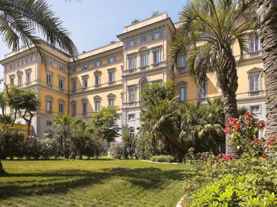 a building with trees and grass