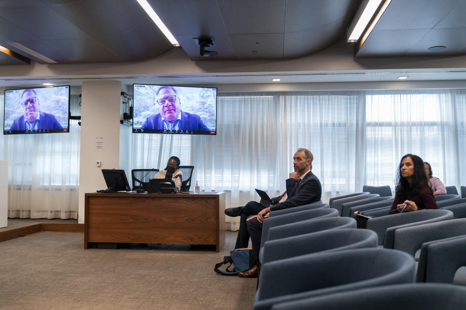 Assistant General Counsel Robert Knop, appears on a screen, while answering questions during a Federal Election Commission public meeting on whether it should regulate the use of AI-generated political campaign advertisements, Thursday, Aug. 10, 2023, in Washington. (AP Photo/Stephanie Scarbrough)