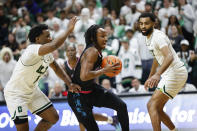 Florida Atlantic guard Michael Forrest, center, drives to the basket ahead of Charlotte guards Montre' Gipson, left, and Brice Williams, right, during the first half of an NCAA college basketball game in Charlotte, N.C., Saturday, Feb. 4, 2023. (AP Photo/Nell Redmond)