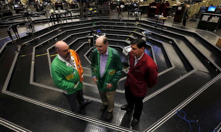 Thomas J. Cashman (C) is joined by his two sons Thomas F. Cashman (L) and Brendon Eugene Cashman on the Chicago Board of Trade grain trading floor in Chicago, Illinois, United States, June 9, 2015. REUTERS/Jim Young