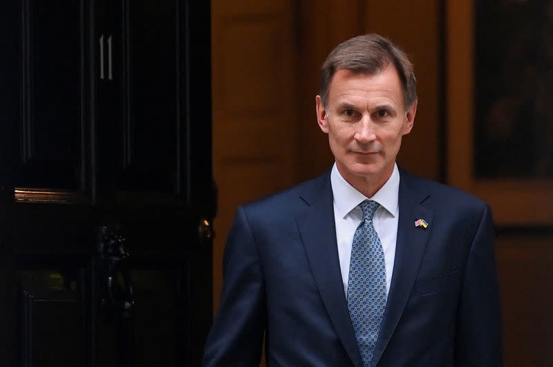 FILE PHOTO: Britain's Chancellor of the Exchequer Jeremy Hunt walks at Downing Street in London