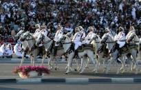 FILE PHOTO: Members of the Qatari royal guards ride horses as they parade during Qatar's National Day celebrations in Doha, Qatar, December 18, 2017. REUTERS/Naseem Zeitoon/File photo