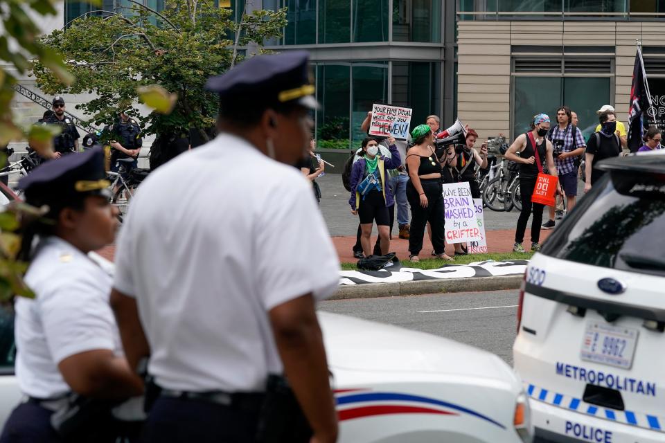 Protesters gather across the street from the Marriott Marquis hotel as former President Donald Trump speaks at the America First Policy Institute agenda summit, Tuesday, July 26, 2022, in Washington. (AP Photo/Patrick Semansky) ORG XMIT: DCPS123