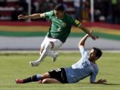 Juan Carlos Zampiery (L) of Bolivia fights for the ball with Alvaro Gonzalez of Uruguay during their 2018 World Cup qualifying soccer match at the Hernando Siles Stadium in La Paz, Bolivia October 8, 2015. REUTERS/David Mercado