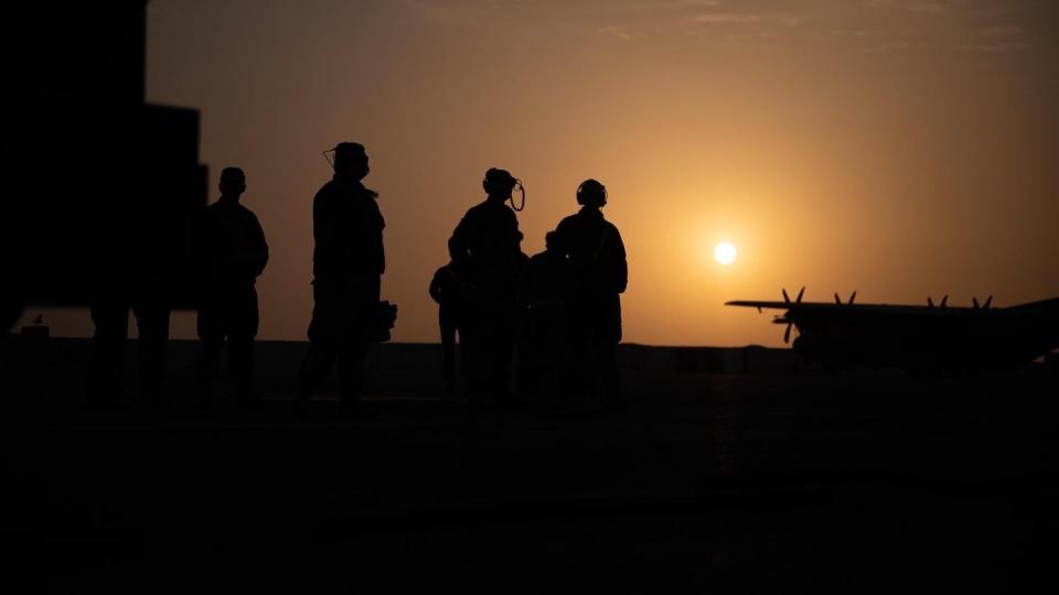 U.S. Air Force maintainers assigned to the 41st Expeditionary Combat Squadron wait for the EC-130H Compass Call aircraft crew to complete their pre-flight checks before takeoff at Ali Al Salem Air Base, Kuwait, Feb. 21, 2022. The Compass Call system employs offensive counter-information and electronic attack capabilities in support of U.S. and coalition tactical air, surface and special operations forces. (U.S. Air Force photo by Senior Airman Daira Jackson)