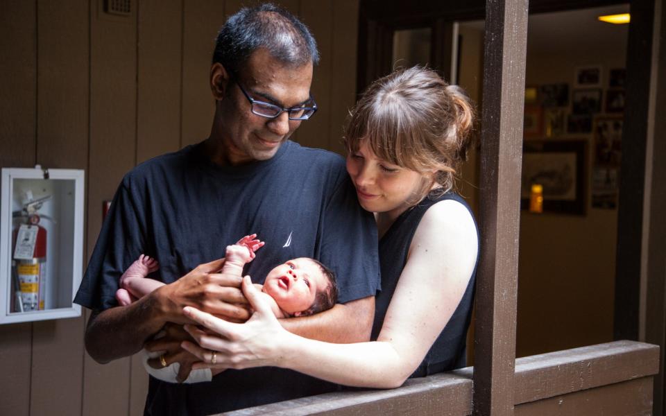 Neurosurgeon Paul Kalanithi with his wife Lucy and baby daughter Cady in July 2014, seven months before his death  - Credit: Gale Gettinger Photography