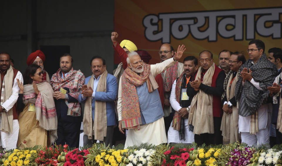 Indian Prime Minister Narendra Modi, center, waves to supporters at a rally of his Hindu nationalist Bharatiya Janata Party in New Delhi, India, Sunday, Dec. 22, 2019. Clashes continued Sunday between Indian police and protesters angered by a new citizenship law that excludes Muslims, as Modi used the rally to defend the legislation, accusing the opposition of pushing the country into a "fear psychosis." (AP Photo)