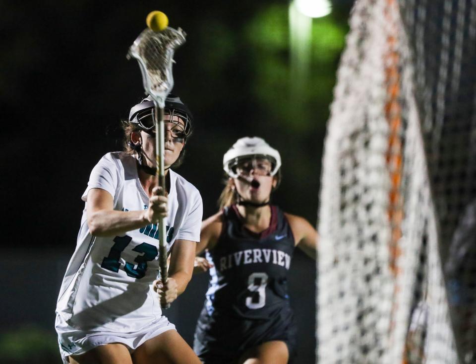 Gulf Coast Sharks attacker Peyton Davidson (13) takes a shot toward the Sarasota Riverview Rams net during the second half of the Class 2A regional quarterfinal game at Gulf Coast High School in Naples on Tuesday, April 18, 2023.