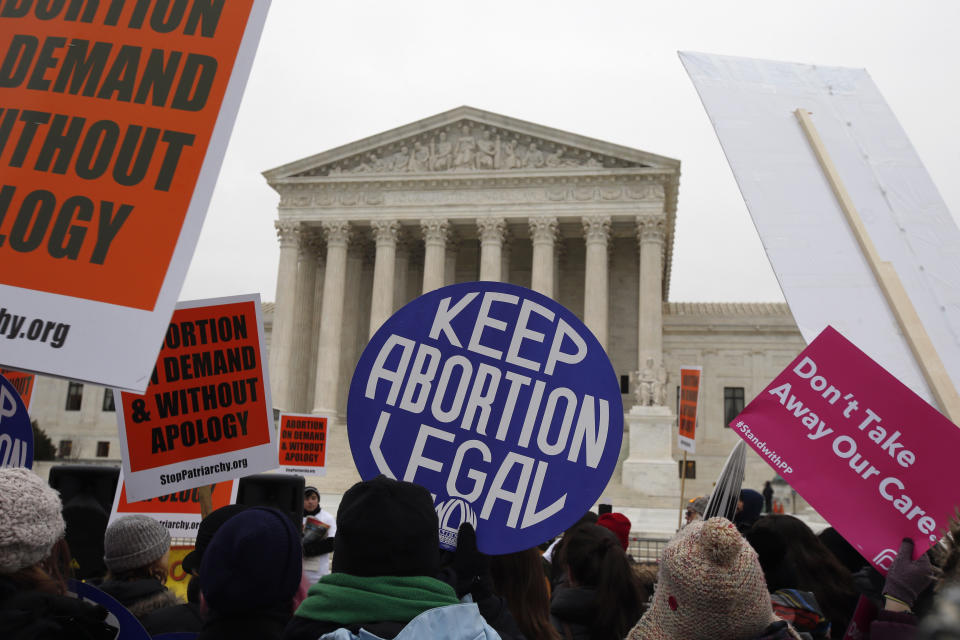 FILE - Pro-abortion rights signs are seen during the March for Life 2016, in front of the U.S. Supreme Court in Washington, Jan. 22, 2016. A North Dakota judge on Wednesday, July 27, 2022, put on hold the state’s trigger law banning abortion while a lawsuit moves forward that argues it violates the state constitution. (AP Photo/Alex Brandon, File)