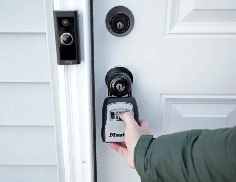 Sinan Falah, an Iraq refugee and real estate agent, unlocks a home before showing it on Sunday, Jan. 14, 2024.