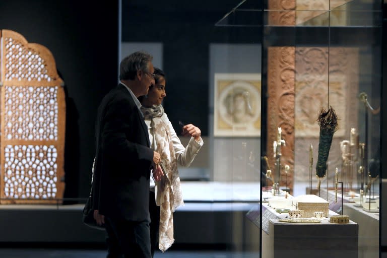 Visitors examine Islamic art works on September 17, 2012 in Paris, during a press visit of the new Department of Islamic Arts at the Louvre, the largest of its kind in Europe, with 3,000 artefacts on display, gathered from Spain to India and dating back to the seventh century AD. Intended to celebrate "The Radiant Face of a Great Civilization" the 100-million-euro project - largely financed by donors from across the Islamic world - will be inaugurated by French President ahead of its official opening on September 18. AFP PHOTO / KENZO TRIBOUILLARD