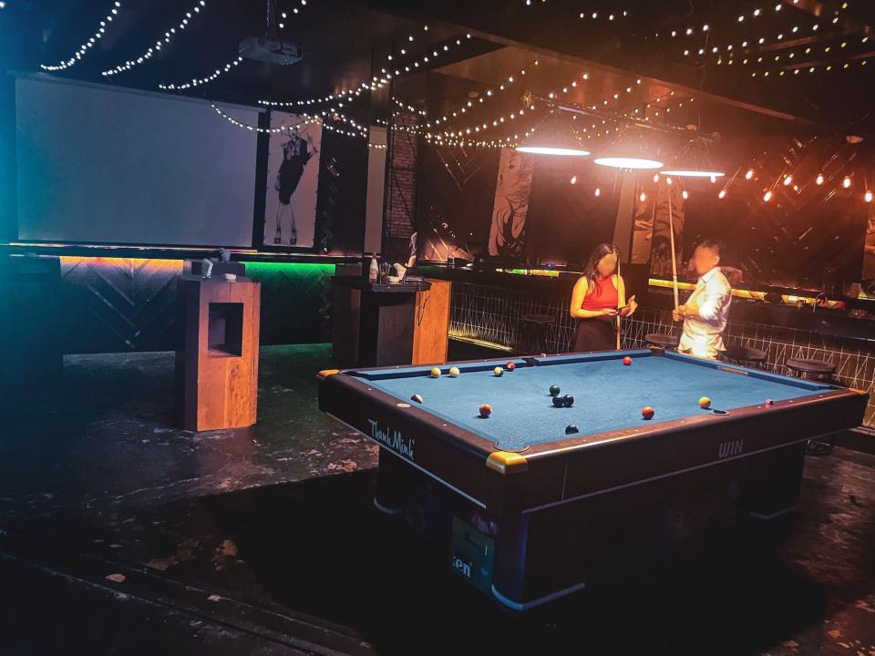 The pool table behind the dancefloor, with barely anyone there.