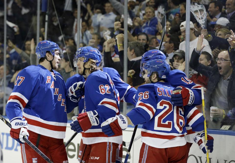 New York Rangers' Ryan McDonagh (27) and Martin St. Louis (26) celebrate a goal by Carl Hagelin (62) during the second period of a second-round NHL Stanley Cup hockey playoff series against the Pittsburgh Penguins, Wednesday, May 7, 2014, in New York. (AP Photo/Frank Franklin II)