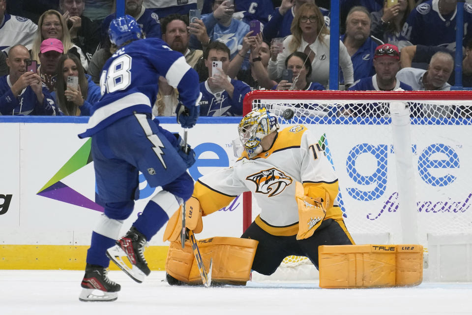 Tampa Bay Lightning left wing Brandon Hagel (38) scores past Nashville Predators goaltender Juuse Saros (74) on a penalty shot during the third period of an NHL hockey game Tuesday, Oct. 10, 2023, in Tampa, Fla. (AP Photo/Chris O'Meara)