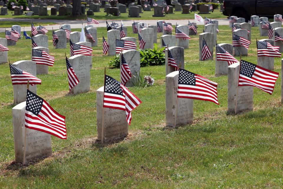 Volunteer flag Veterans' graves in preparation for Memorial Day at Melrose Cemetery in Brockton on Tuesday, May 23, 2023.   