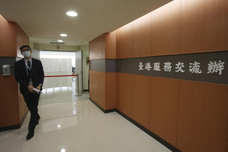 A staff member walks out of the Taiwan Hong Kong Service Exchange Office after its opening ceremony in Taipei, Taiwan, Wednesday, July 1, 2020. Taiwan officially opened the specialized office on Wednesday to support Hong Kong people seeking to move to Taiwan after China’s passage of a national security law for Hong Kong. (AP Photo/Chiang Ying-ying)