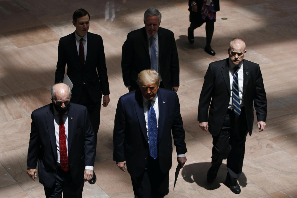 President Donald Trump arrives at the Hart Senate Office Building on Capitol Hill in Washington before meeting with Republican Senators at their weekly luncheon, Tuesday, May 19, 2020. Following Trump are White House Senior Adviser Jared Kushner, top left, and White House chief of staff Mark Meadows. (AP Photo/Patrick Semansky)