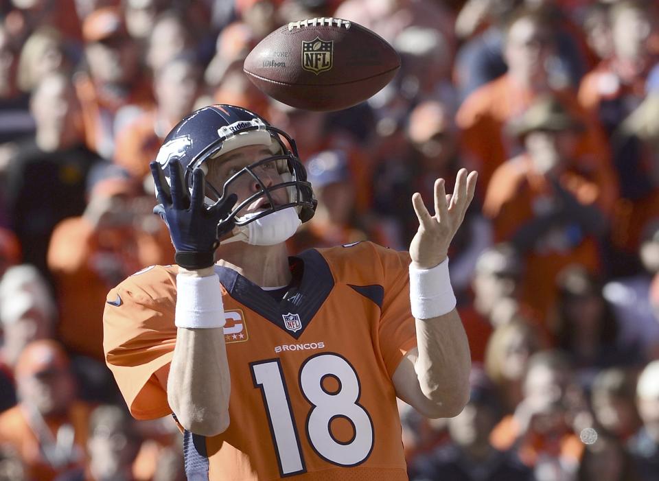 Denver Broncos quarterback Manning bobbles a snap before throwing a pass against the New England Patriots during the first quarter