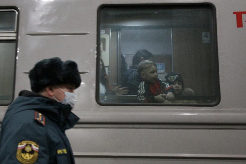 Children who evacuated from the Donetsk region, the territory controlled by a pro-Russia separatist governments in eastern Ukraine, are seen through a train window as they wait to be taken to temporary residences in Nizhny Novgorod region (AP)