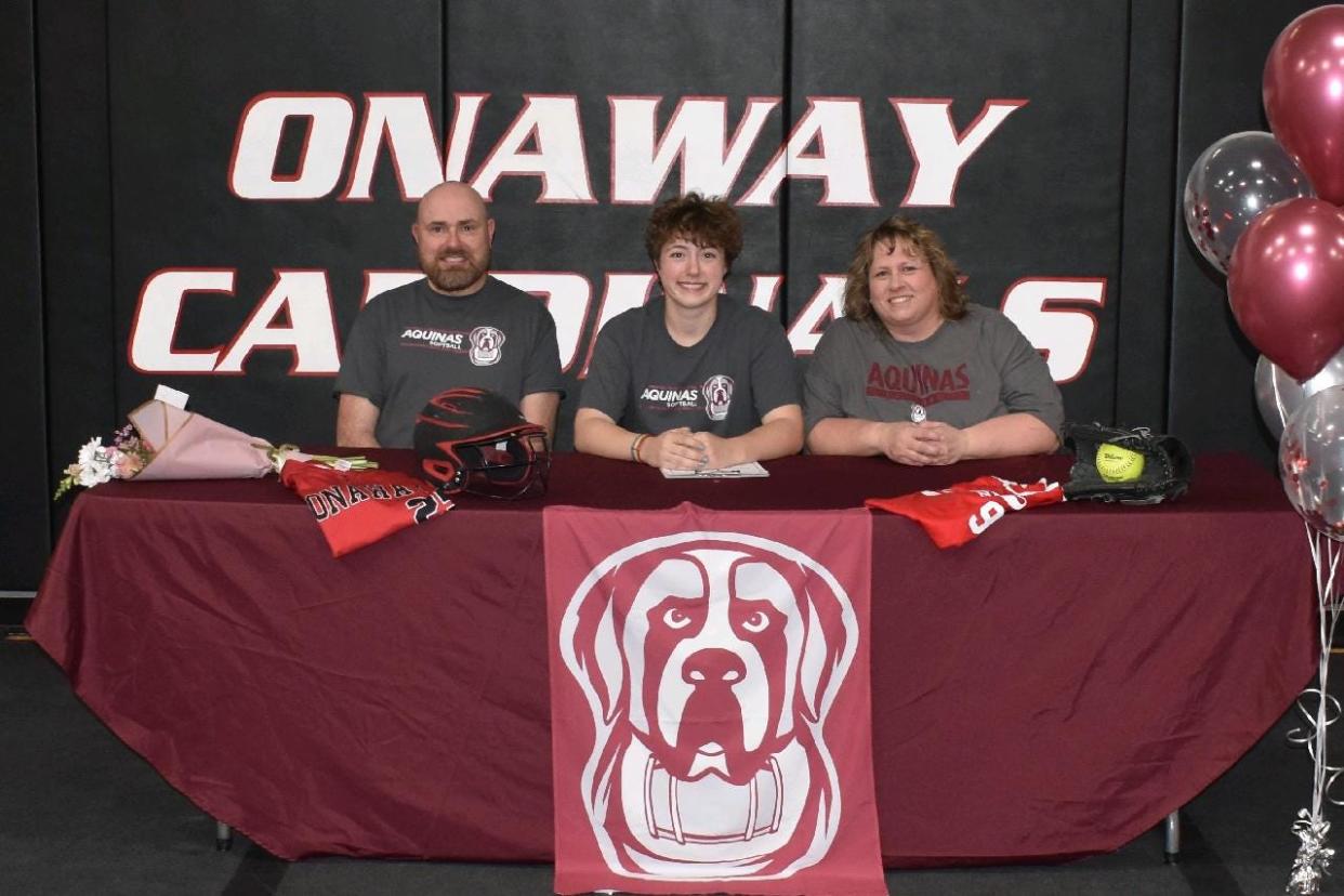 Onaway senior Kenzie Robbins (middle) recently committed to play softball at Aquinas College next season. In this photo with Robbins are her parents, Jeffrey and Tina Robbins.