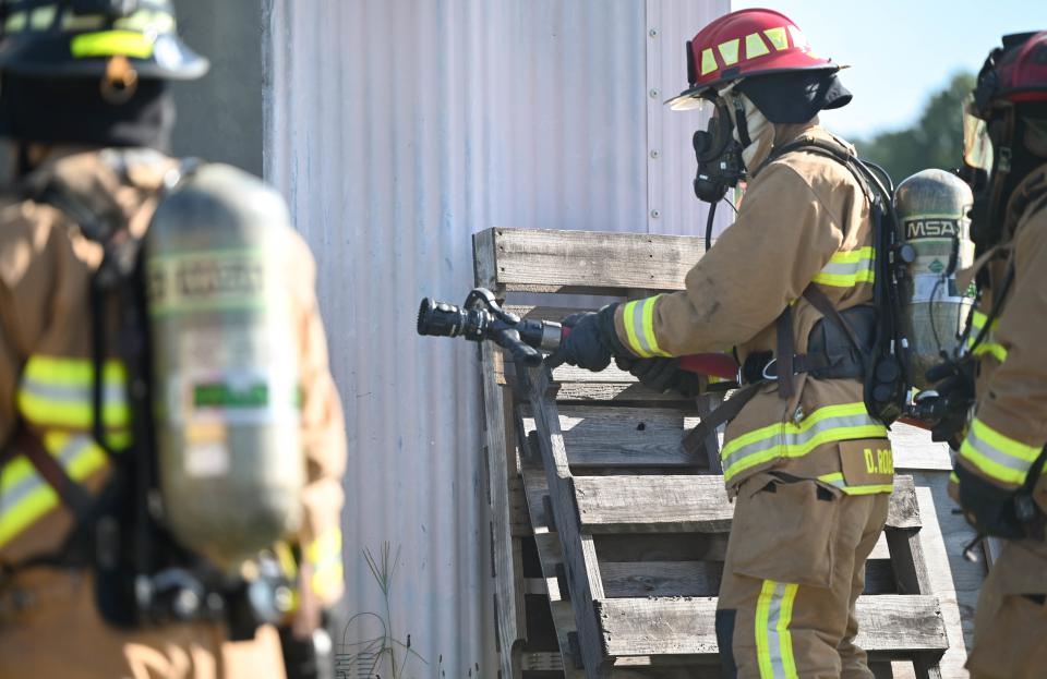 U.S. Air Force Staff Sgt. Denver Robles, a crew chief with the 908th Civil Engineer Squadron, prepares to extinguish a structural fire during a training exercise, August 5, 2022, at Maxwell Air Force Base, Alabama. Regular training helps keep firefighters sharp and confident in their skills.