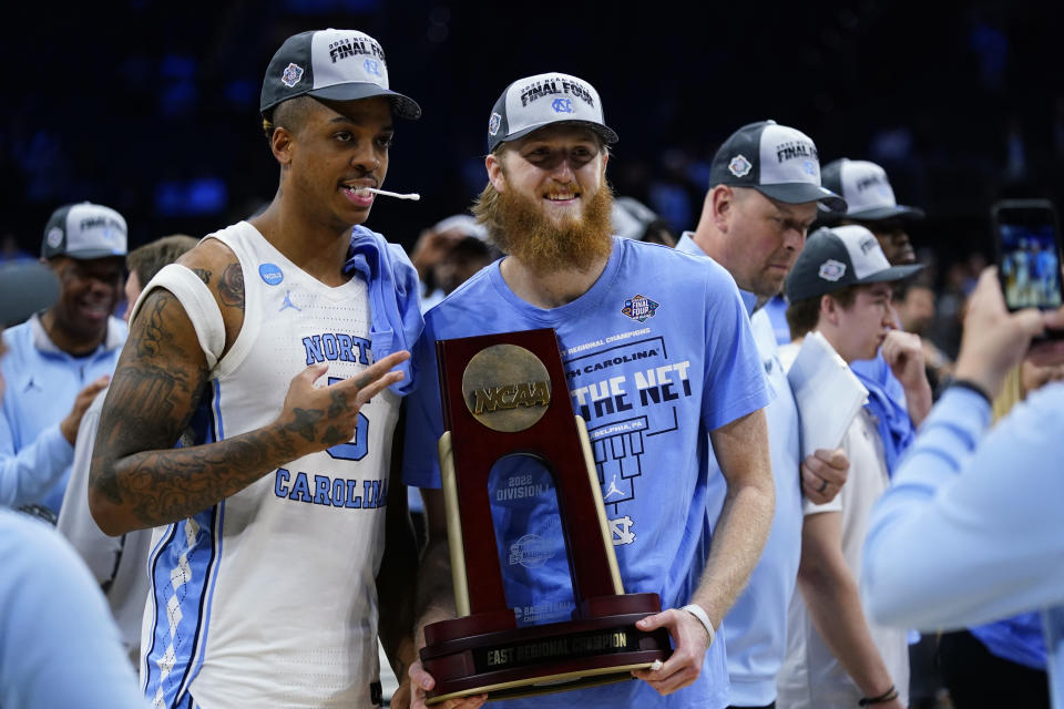 North Carolina's Armando Bacot, left, and Brady Manek celebrate after North Carolina won a college basketball game against St. Peter's in the Elite 8 round of the NCAA tournament, Sunday, March 27, 2022, in Philadelphia. (AP Photo/Chris Szagola)