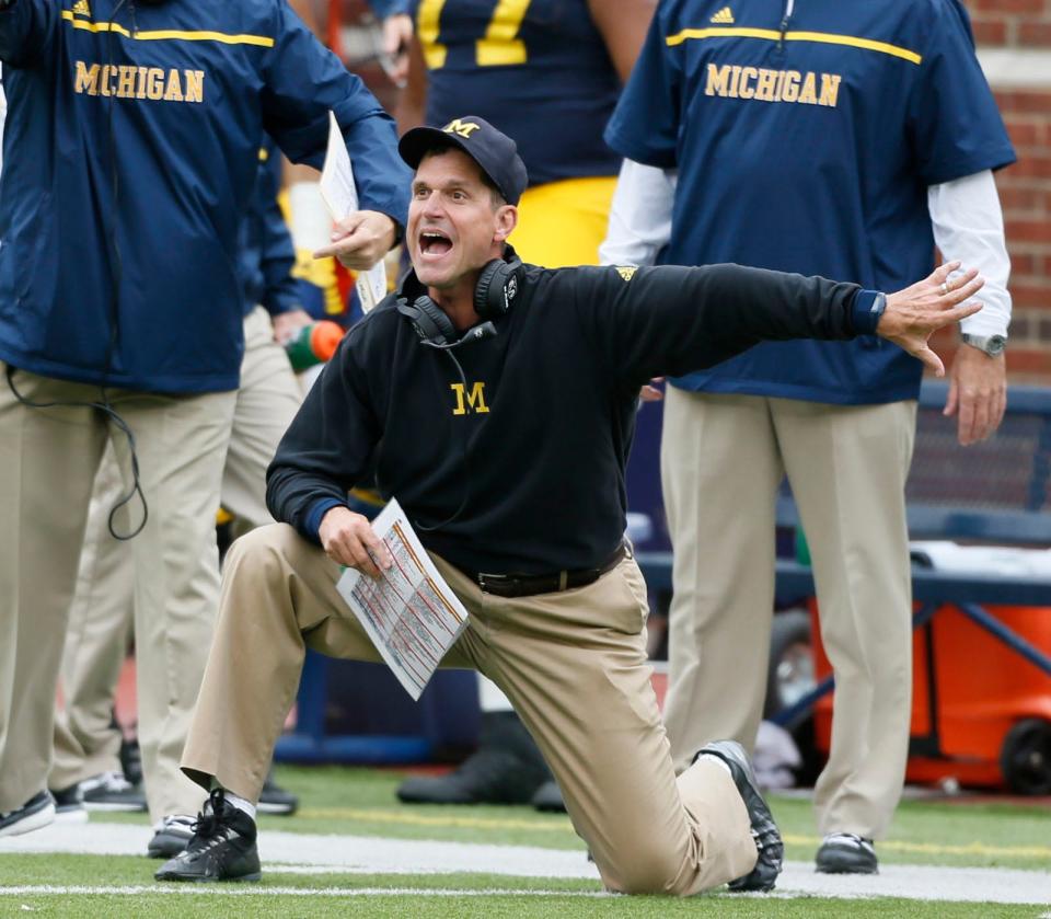 Michigan head coach Jim Harbaugh arguing a roughing the punter penalty late in the second quarter against Oregon State at Michigan Stadium on Saturday, Sept. 12, 2015, in Ann Arbor.