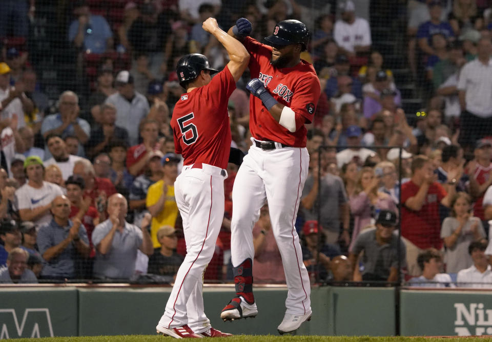 Boston Red Sox's Franchy Cordero, right, is congratulated by teammate Enrique Hernandez (5) after both scored on a two-run home run by Cordero during the second inning of a baseball game against the Toronto Blue Jays at Fenway Park, Wednesday, Aug. 24, 2022, in Boston. (AP Photo/Mary Schwalm)