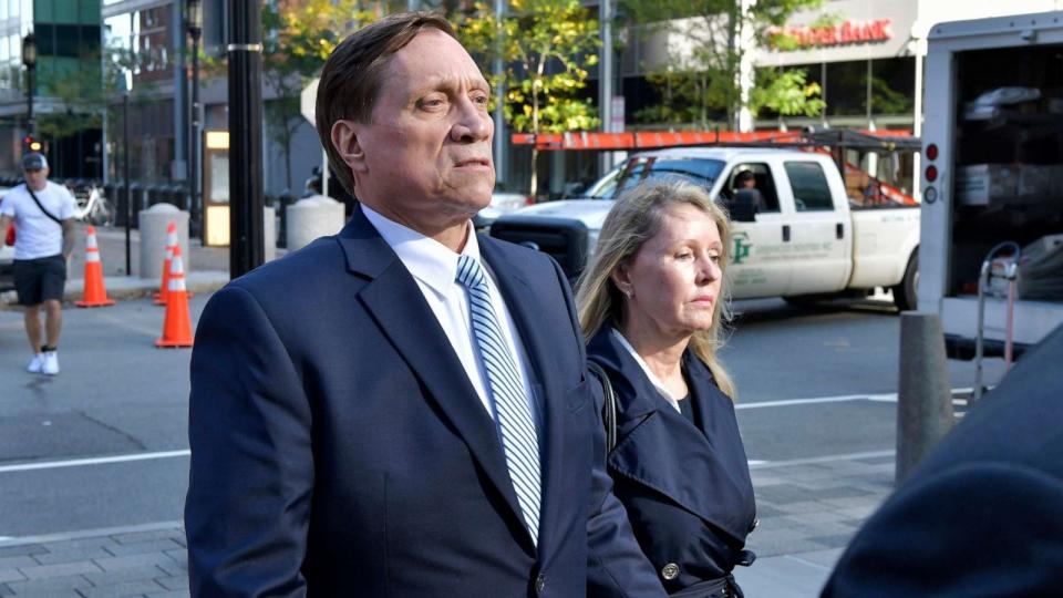 PHOTO: John Wilson, left, and his wife leave federal court after he was found guilty of participating in a fraudulent college admissions scheme, Oct. 8, 2021, in Boston. (Josh Reynolds/AP)