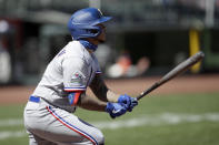 Texas Rangers' Willie Calhoun swings for an RBI sacrifice fly against the San Francisco Giants during the seventh inning of a baseball game Sunday, Aug. 2, 2020, in San Francisco. (AP Photo/Ben Margot)