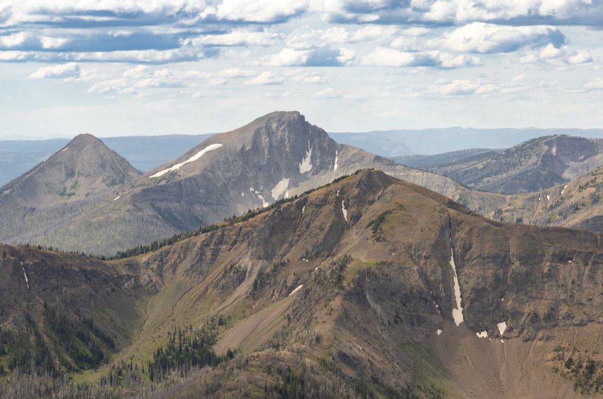 Aerial of First Peoples Mountain, Yellowstone National Park, and surrounding mountains on a bright sunny day
