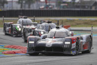 The Toyota TS050 Hybrid No7 of the Toyota Gazoo Racing Team driven by Mike Conway of Britain, Kamui Kobayashi of Japan and Jose Maria Lopez of Argentina is seen in action ahead of the The Rebellion R13 No3 and the The Rebellion R13 No1 during the 88th 24-hour Le Mans endurance race, in Le Mans, western France, Sunday, Sept. 20, 2020. Due to coronavirus crisis, the race takes place without spectators. (AP Photo/David Vincent)