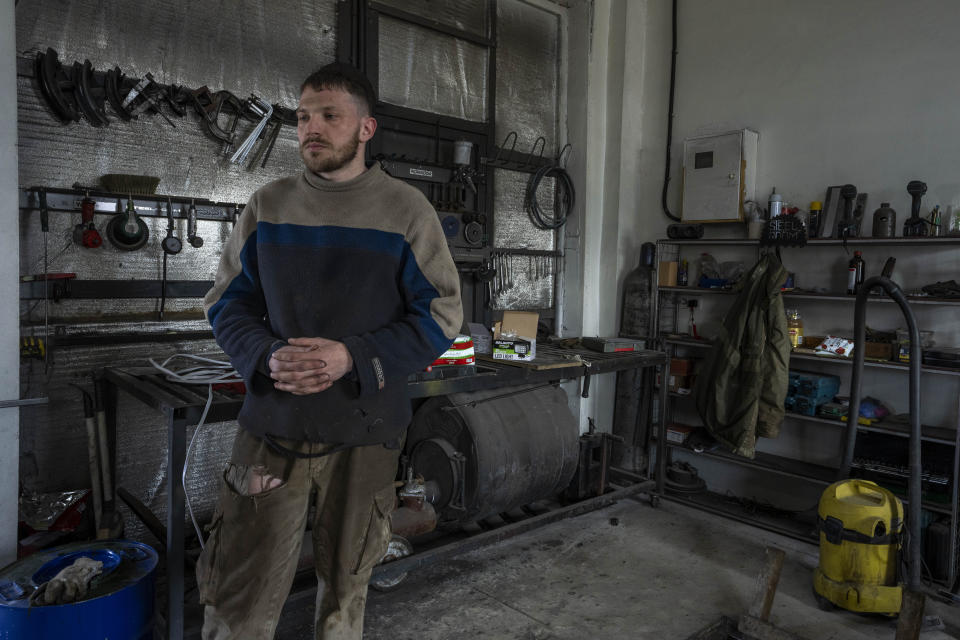 Car welder Ostap Datsenko, 31, pauses during an interview at a welding workshop in Lviv, western Ukraine, Sunday, March 27, 2022. Datsenko says he was ready like all Ukrainian men to be called up to fight. But he had no combat experience, meaning his time was yet to come. Until then, he said, “I’m doing what I can.” (AP Photo/Nariman El-Mofty)