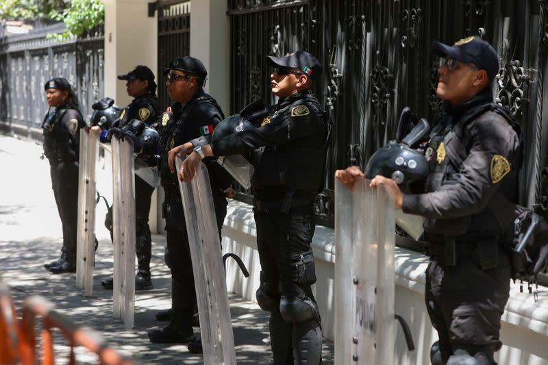 Police officer stand watch outside the Ecuadorean embassy in Mexico City after Ecuadorean authorities arrested former Vice President Jorge Glas