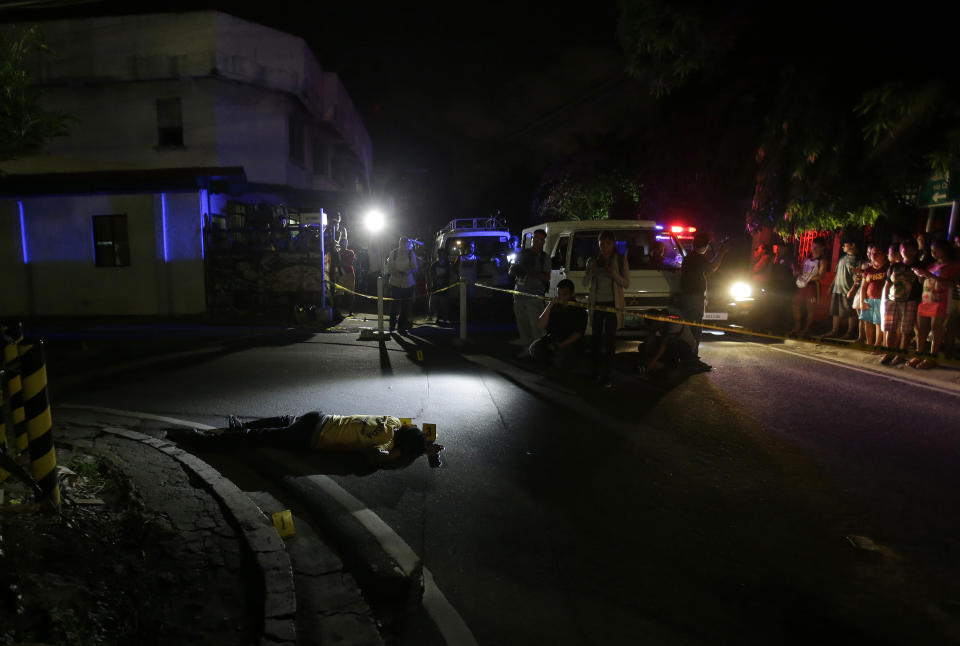 FILE - In this Sept. 5, 2016 file photo, the body of alleged drug user Marcelo Salvador lies on the pavement after being shot by unidentified men in Las Pinas, south of Manila, Philippines. Drug dealers and drug addicts, were being shot by police or slain by unidentified gunmen in mysterious, gangland-style murders that were taking place at night. Salvador became a victim, the casualty of a vicious war on drugs that has claimed thousands of lives as part of a campaign by Philippine President Rodrigo Duterte. (AP Photo/Aaron Favila, File)