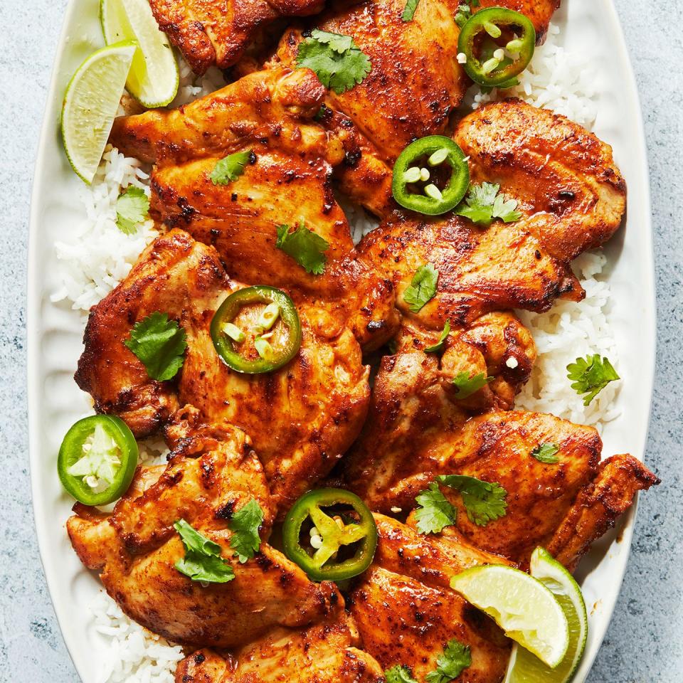 baked chicken thighs with lime wedges and jalapeno slices