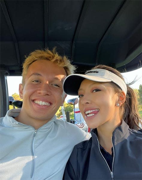 Alexander Albon and Lily Muni in golf cart