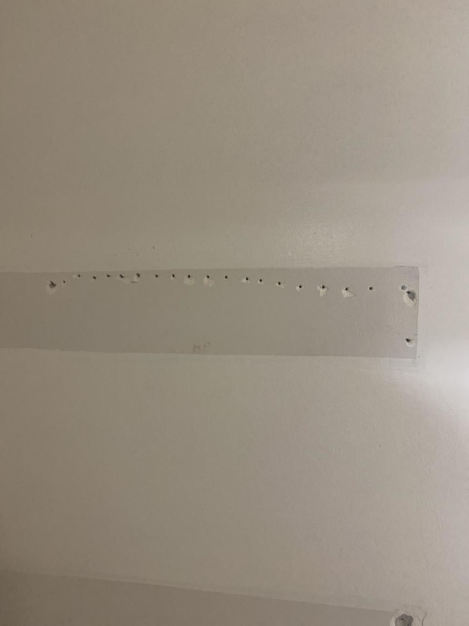 A row of small holes in a wall